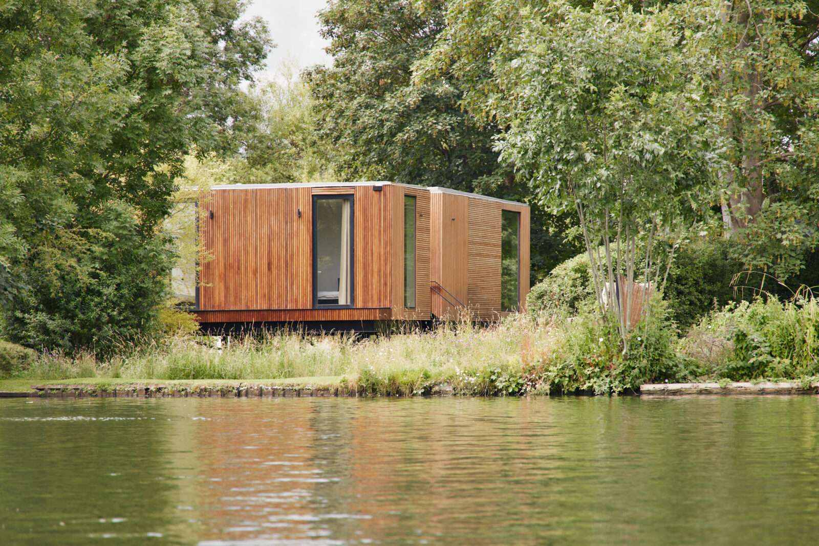 A wooden stilt house on the bucolic car-free island of Wheatleys Eyot, with a nearby creek for wild swimming